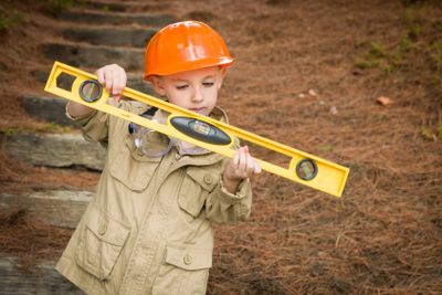Adorable Child Boy with Level Playing Handyman Outside