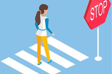 Woman crossing road near stop sign. Pedestrian walks...