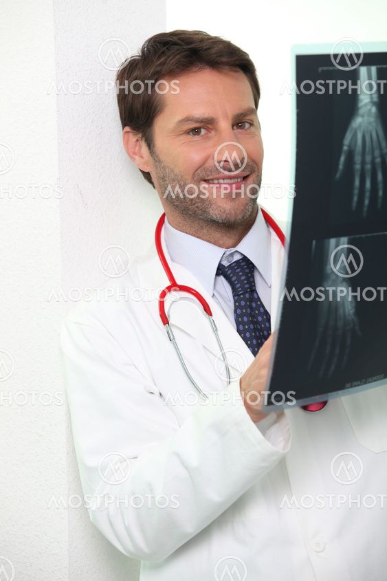 Hospital doctor examining an x-ray of someone's hand