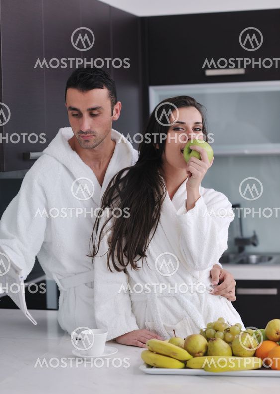 young couple have fun in modern kitchen