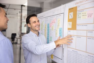 Positive male multiethnic partners brainstorming on...