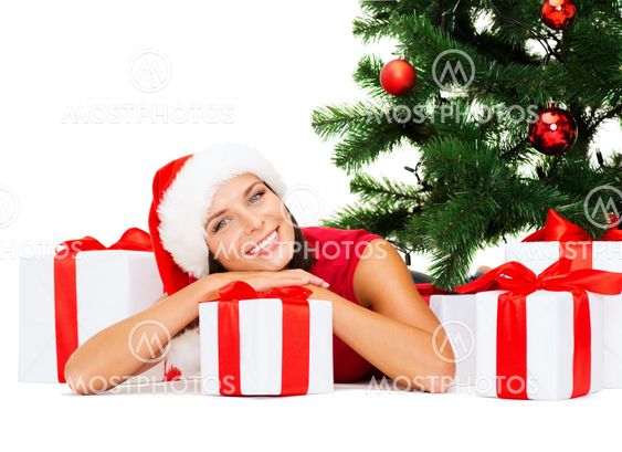 smiling woman in santa helper hat with gift boxes