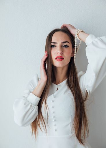 Portrait of a beautiful woman in a white summer dress...