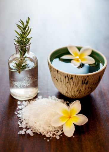 Flowers, rosemary and bath salt in spa for beauty,...