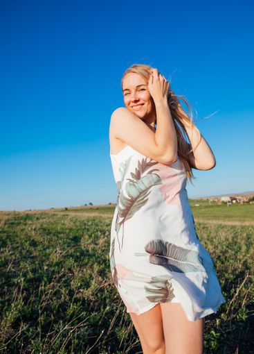 a woman in a beautiful summer dress in nature in a clearing