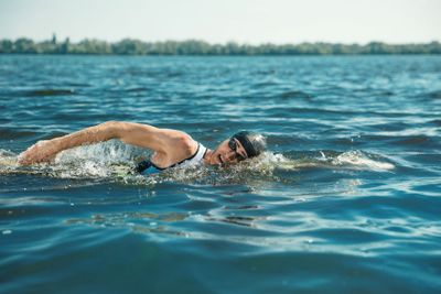 Professional triathlete swimming in river's open water