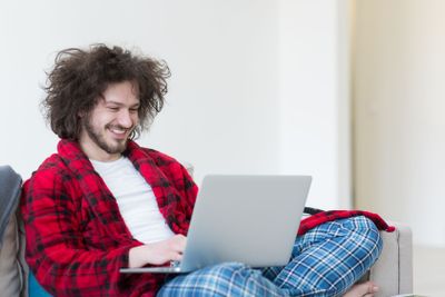 man freelancer in bathrobe working from home