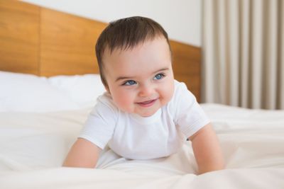 Happy baby boy in bed