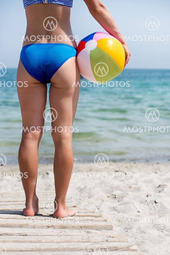girl with ball on the beach
