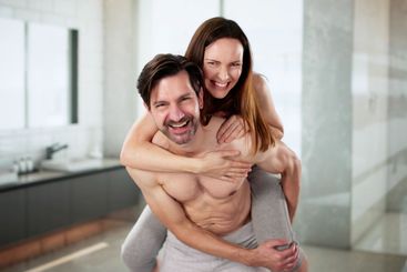 Smiling couple in bathroom enjoying a fun morning...
