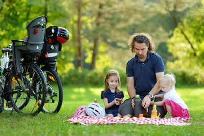 Young father and his daughters having a picnic