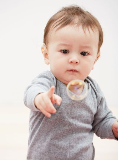 Baby, bubbles and playing game for fun childhood...