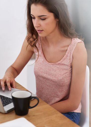 Research, reading and girl at laptop in home office for...