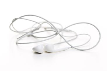 Pair of earphones close up on grey background