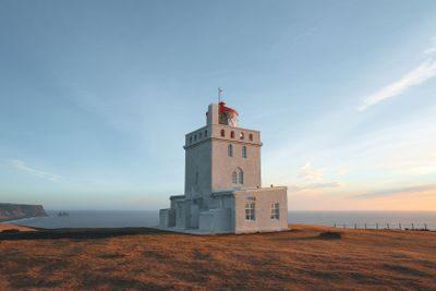lighthouse at beautiful icelandic seacoast at sunny day,...