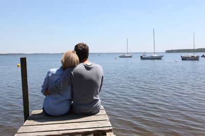 Couple sitting on the end of a pontoon