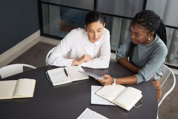 Tablet, notebook and business women in office planning,...