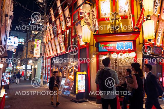 Osaka, Japan - April 2016: Nightlife on street of Osaka City along with shops, bars, and restaurants decorated with neon signs at night