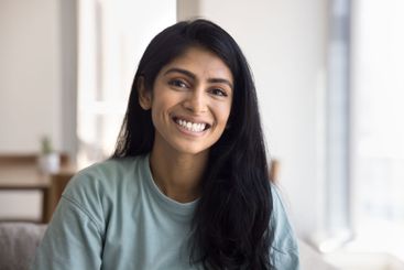 Head shot portrait of beautiful Indian female posing for...