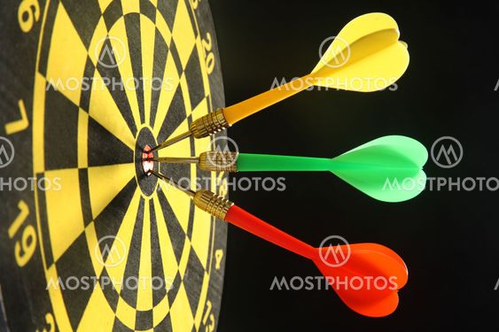 Three colourful darts in the bullseye.