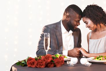 Beautiful man and woman in love cuddling during...