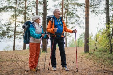 Hiking tourism adventure. Senior couple man woman...