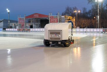 Skate rink ice resurfacing machine at work during...