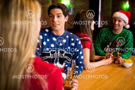 Smiling friends with christmas accessory