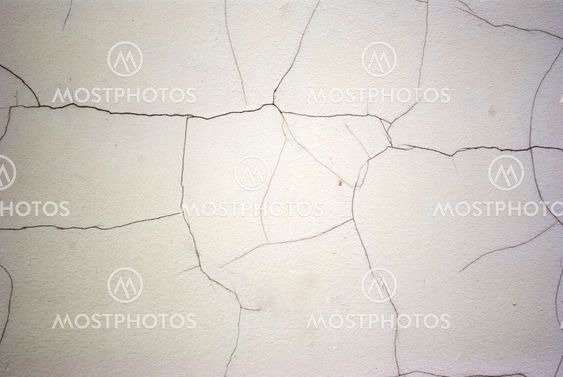 Old white wall with cracks