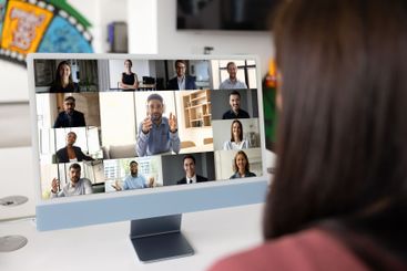 Female employee using computer screen for video...