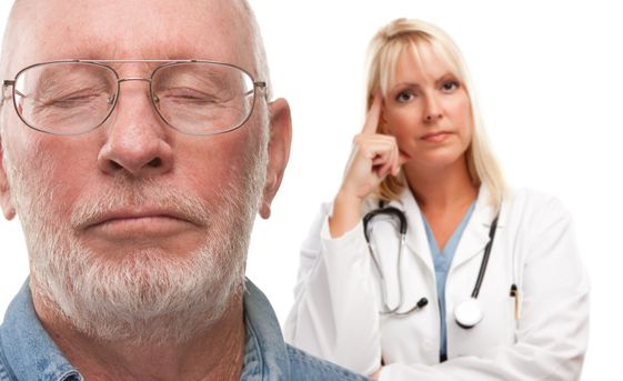 Concerned Senior Man and Female Doctor Behind