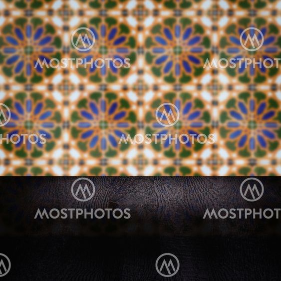 Wood table top and blur vintage ceramic tile pattern wall