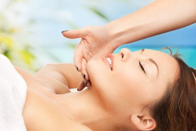 woman on resort getting face spa treatment