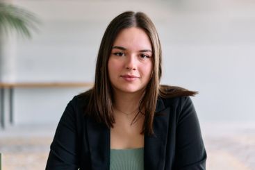 A close up portrait of a young businesswoman engaged in...