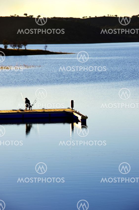 Fisherman silhouette at sunset