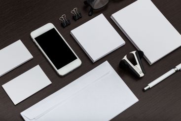 Workspace arrangement with stationery, smartphone, and...