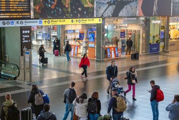 Travelers inside the Roma Termini railway station, in...