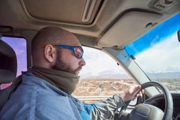 Side portrait of a man traveling by car, concentrating...