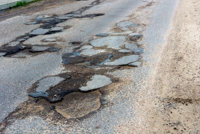 Old  damaged asphalt road 