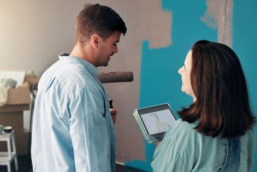 House, painting and couple with tablet, screen and...