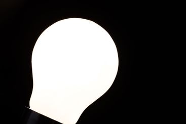 Close-up of electrical bulb on black background