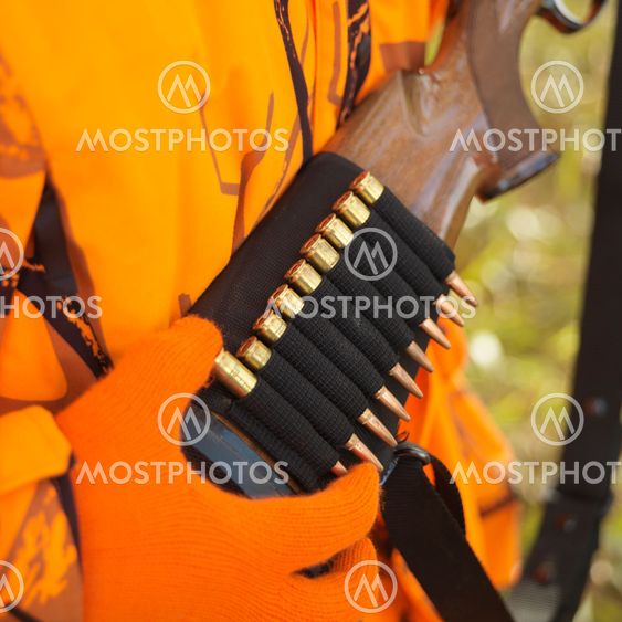 Hunter removing bullet from ammo holder.