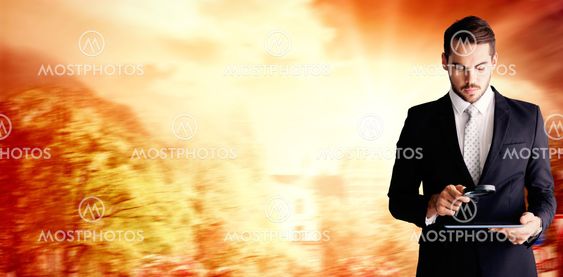 Composite image of concentrated businessman using magnifying glass