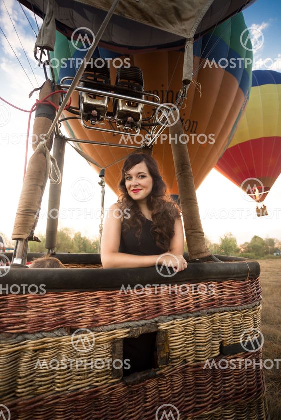 Portrait of beautiful woman posing at hot air balloon...