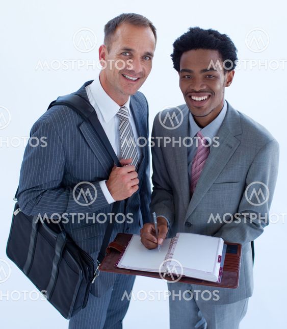 Smiling businessmen writing in a business diary