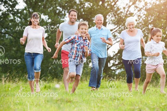 Multi Generation Family Running Across Field Together