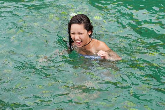 Girl swims with tropical fish