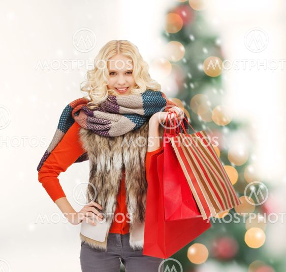 teenage girl in winter clothes with shopping bags