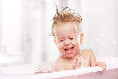 happy funny  baby  laughing and bathed in bath