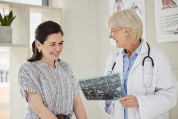Women, doctor and patient with scan at office for...